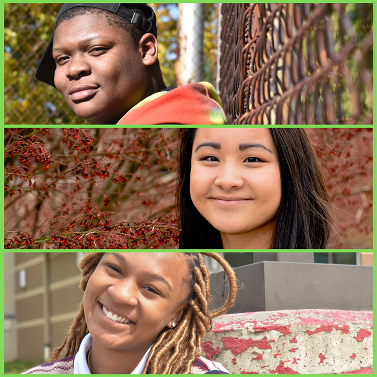 A black high school male looks forward. He is wearing a black ballcap sideways and a tie dye hoody while leaning against a rusted chain link fence. An Asian female student looks forward She has dark eyes and hair and stands in front of red berry bushes.  A multi-racial middle school female looks forward while leaning against a light post base with peeling red paint. She wears her hair half up and away from her face in long blonde faux locs that go past her white colored tan and maroon striped polo. 